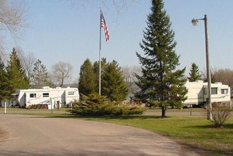Officials oversee Campground Expansion in Washburn with a group of RV's parked in a park.