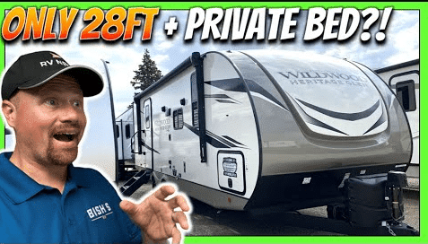 A man is standing in front of a rv with the words only 28ft private bed.