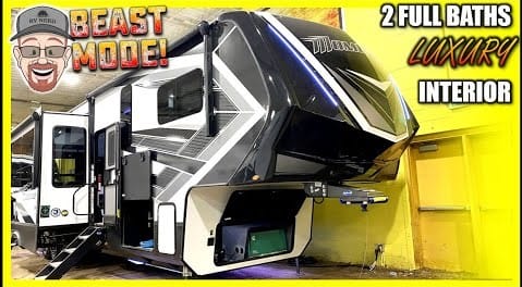 Description: The Ultimate Toy Hauler of 2022, a picture of an RV parked inside a garage.