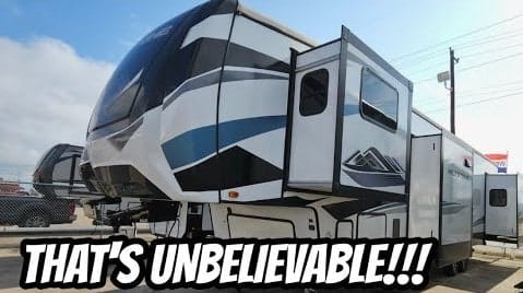 A unique black and white rv with the words 'that's unbelievable'.