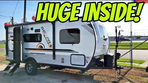 An off-road RV trailer with a sign that says huge inside.