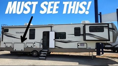 A Wildwood Elite RV, a must-see for RVers, parked in a lot.