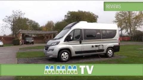 The Italian-Style compact campervan is parked in front of a house.
