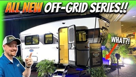 A man is standing in front of an Off-Grid RV.