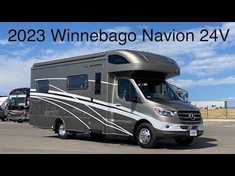 The luxurious Mercedes-Benz Winnebago Navion 24V is parked in a lot, exuding comfort and style.