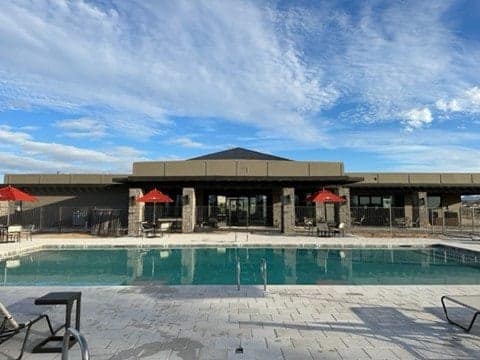 First-Class pool area at River Sands RV Resort with lounge chairs and umbrellas overlooking the beautiful Arizona scenery.