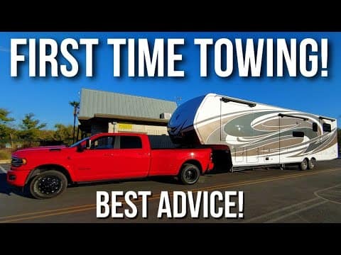 Beginners towing an RV on the open road with a red truck for the first time.