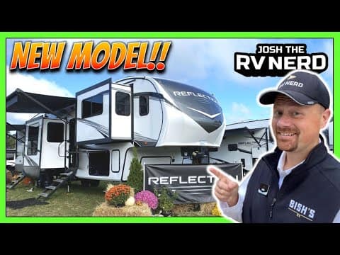 A man is standing in front of a Grand Design RV 370FLS.