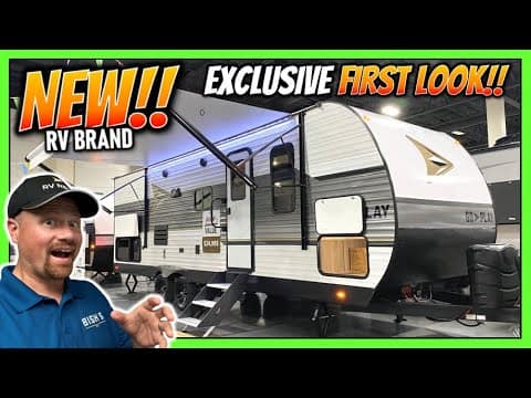 A man is standing in front of a new rv brand, the Wayfinder GO PLAY, a 26BHS Travel Trailer.