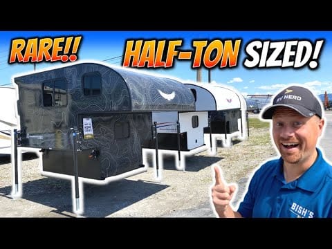A man is standing next to a lightweight RV with the words "half-ton sized" prominently displayed