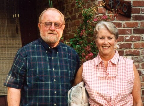 Judy Miller, an industry pioneer, and a man standing in front of a brick house.