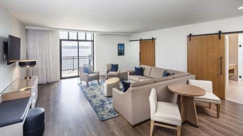 A lodge with a living room and a breathtaking view of the ocean.
