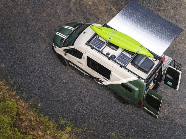 An aerial view of a green Jayco van with a surfboard on top, part of the Adventure Ready RV Program.