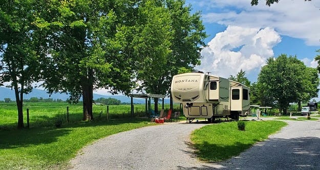 An RV parked on a gravel road at Spacious Skies Campgrounds.