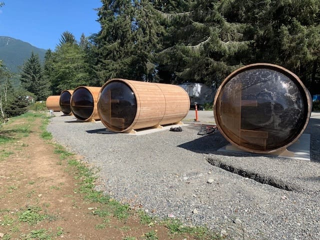 Alternative accommodation - wooden barrels on a gravel road.