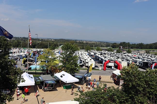 A lot of rv's parked in a parking lot during the Hershey RV Show, a 5-day event with significant attendance.