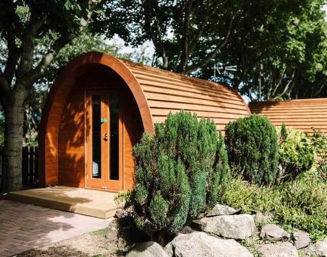A small wooden cabin in a garden operated by Verdant Leisure, a U.K. holiday park operator.