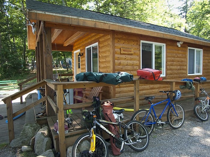 A cabin nestled in the serene surroundings of Interlochen State Park, providing an immersive experience of Michigan's Camping Adventure.
