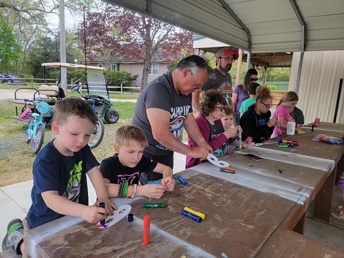 A group of children are making crafts at a Launches-themed table.