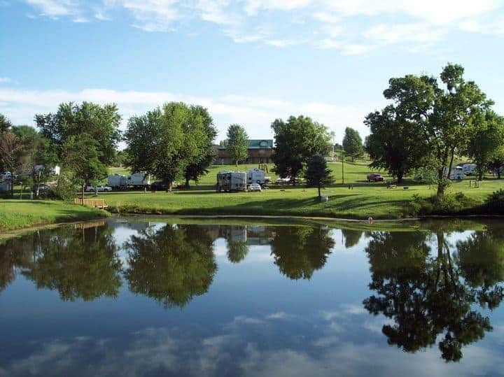 AOK Campground, undergoing renovations, offers an adventurous experience with a serene pond in the background.