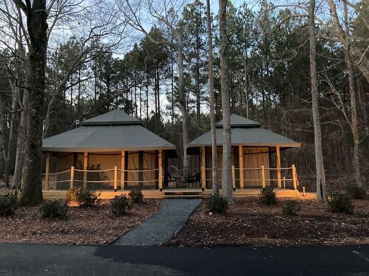 Two imported Safari tents in the woods at dusk at a Georgia Resort, RVC Outdoor Destinations.