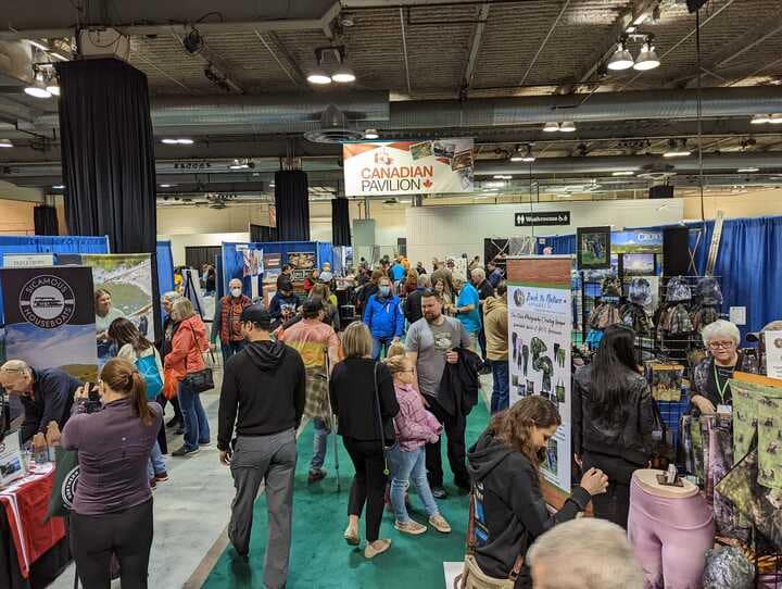 A crowd of people at an outdoor trade show in Calgary.