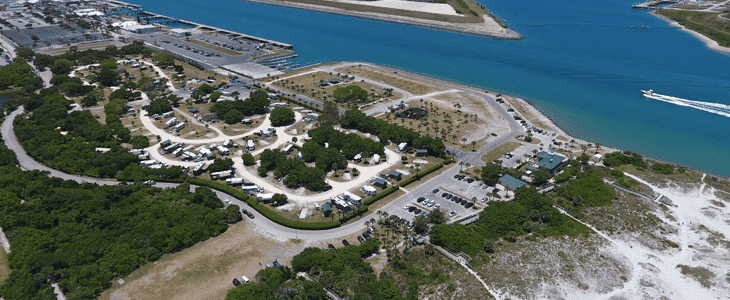 An aerial view of the Jetty Park Campground, an rv park near the water.