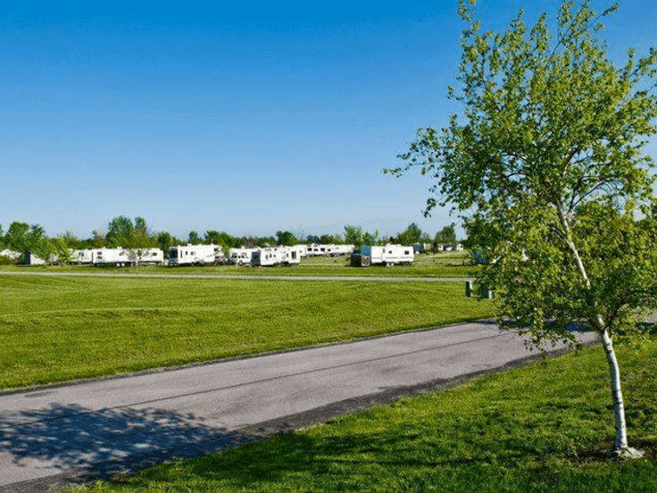 Erie Landing, a scenic RV park, boasts a lush grassy field adorned with towering trees. With plans for expansion in the works, Erie Landing aims to become a thriving resort destination.