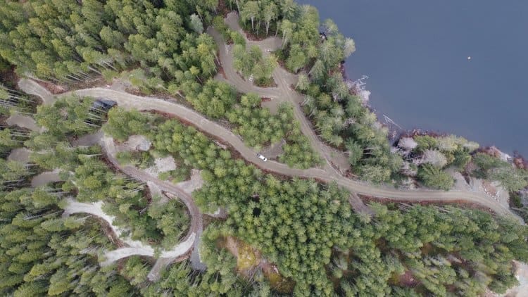 An aerial view of a road near Loon Lake, weaving through the forest.