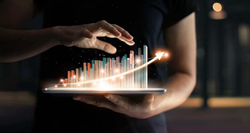 A person holding a tablet displaying a graph representing the impact of the pandemic on the German economy.