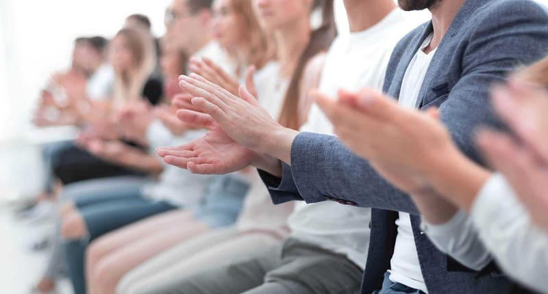 A group of people clapping in an auditorium during the East of England Tourism Awards.