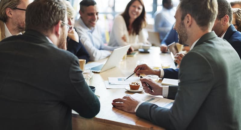 Save The Date: A group of business people sitting around a table November, discussing ideas for the BCLCA Lodging and Camping Ideas Forum.