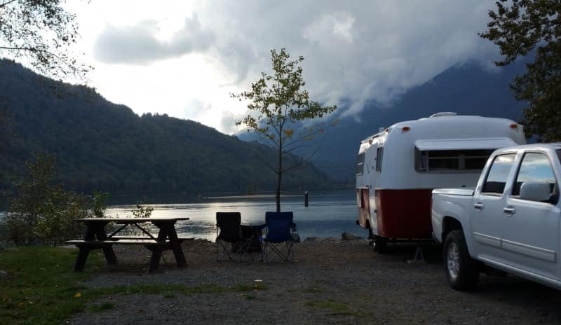 Kilby Campground, an RV-friendly site located next to a picturesque lake with majestic mountains in the background, now opens for online reservations.
