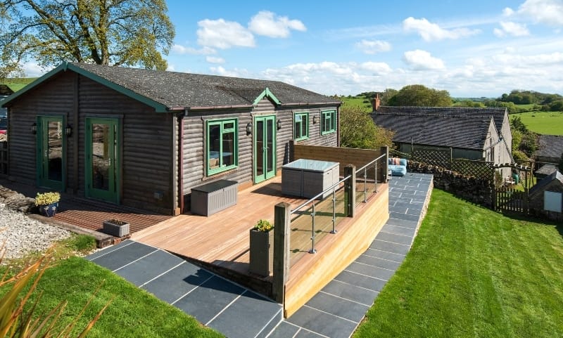 An accessible log cabin in the countryside, perfect for a camper's retreat or pet-friendly accommodations.