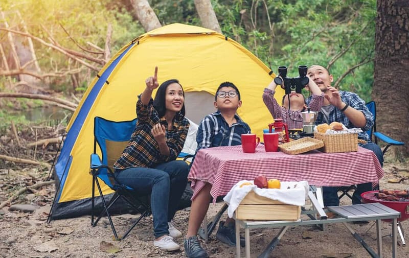 A group of people sitting at a picnic table during CCRVC's Camper Appreciation Weekend.