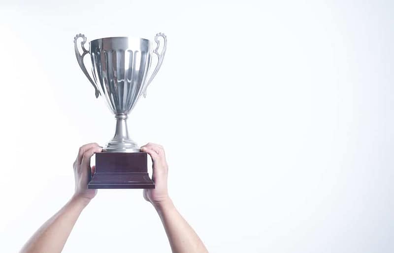 Person holding a silver trophy at the Australian Tourism Awards.