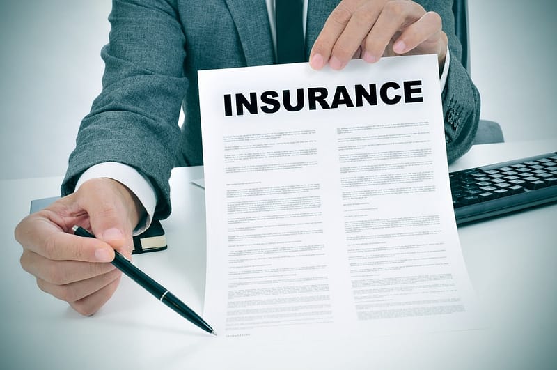 A man holding a paper with the word insurance on it, highlighting the recent changes in Florida RV Park Insurance.