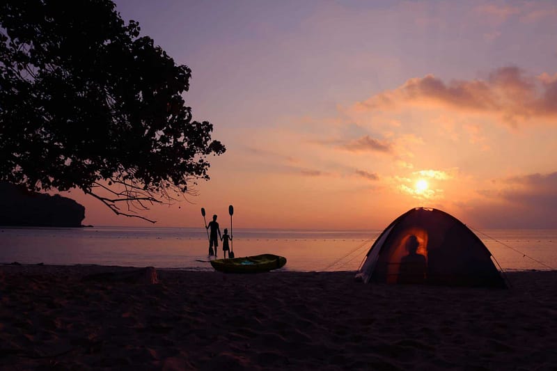 A tent set up at Porpoise Bay Provincial Park beach in British Columbia, creating a picturesque sunset holiday getaway.