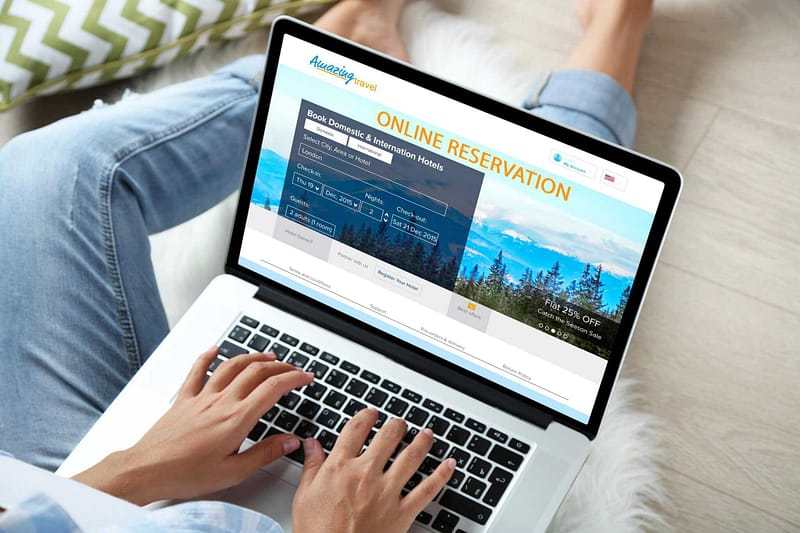A woman is using a laptop to make campground reservations for Charlottenburgh Park.