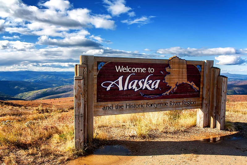 Welcome to Alaska sign, celebrating the Great American Outdoors Act and the beauty of Alaska's outdoor economy.