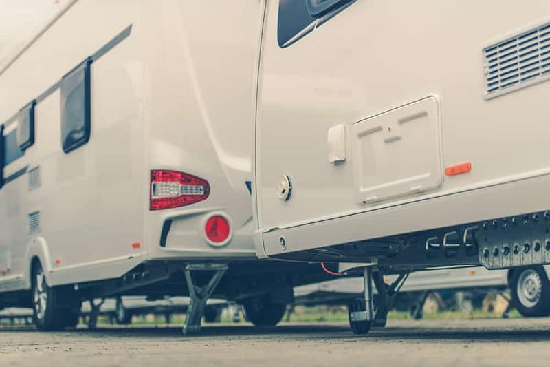 A group of RVs parked in a parking lot, reflecting the decline in Canada RV wholesale shipments according to the CRVA Report.