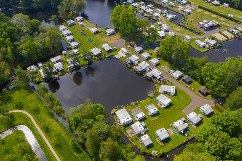 An aerial view of a Europe rv park near a lake, showcasing the Camping Boom.