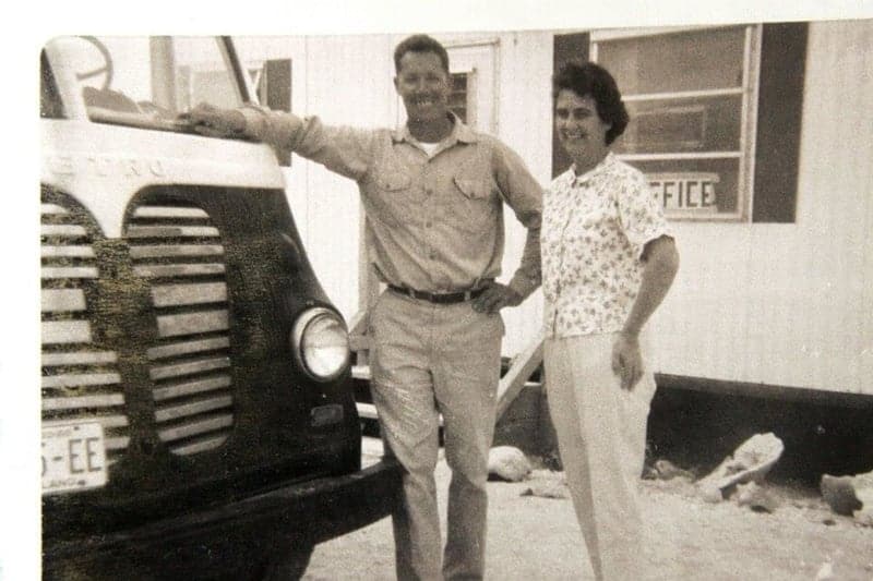 A black and white photo of a man and woman standing in front of a truck at Boyd's Key West Campground.