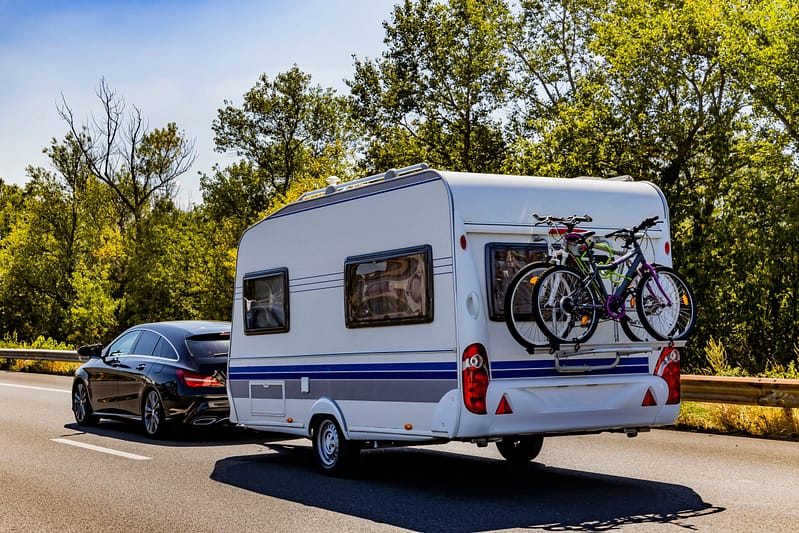 A caravan with a bicycle on the back, perfect for camping at Bathurst Showground.