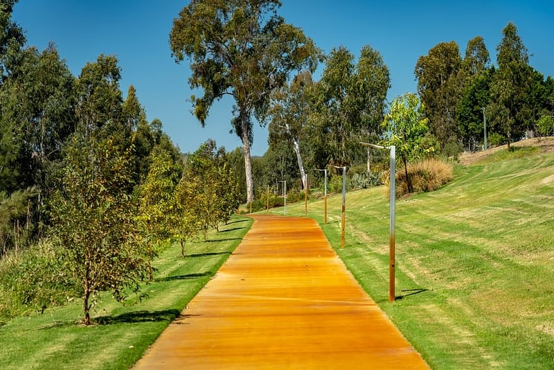 A yellow path leading to a grassy area, perfect for local tourism in Queensland.