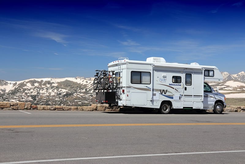 A white Winnebago parked on a road.