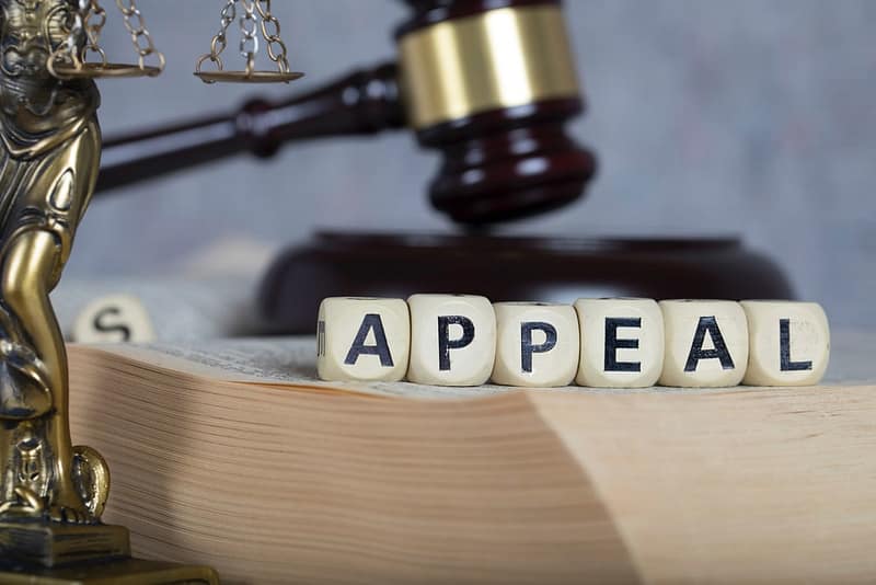A Forest Heights Campground Appeal is visually depicted on a book with a gavel resting atop, symbolizing the decision-making authority of the Board as it considers the case related to Alberta County.