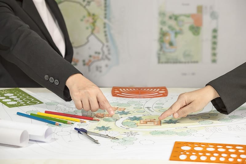 Two business people working on a plan for a garden.