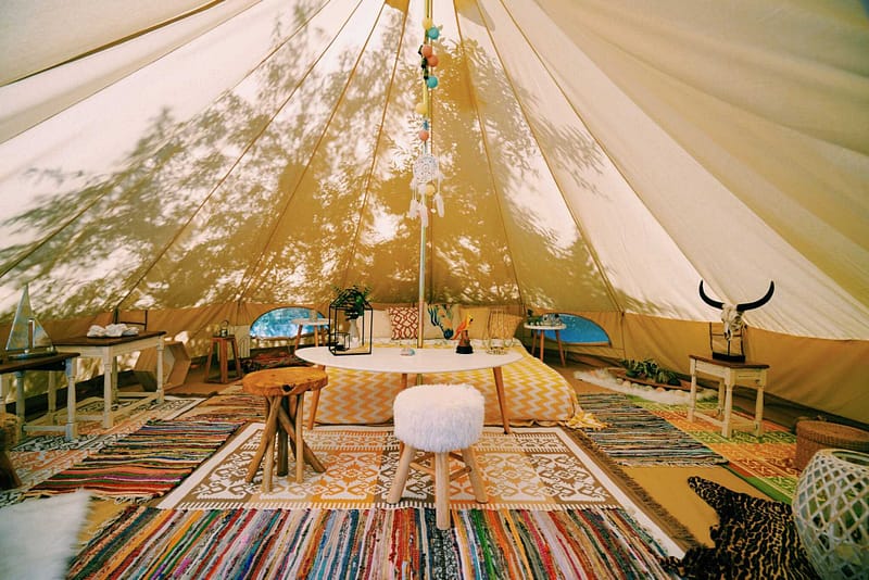 A room in a Utah glampground tent with a rug on the floor.