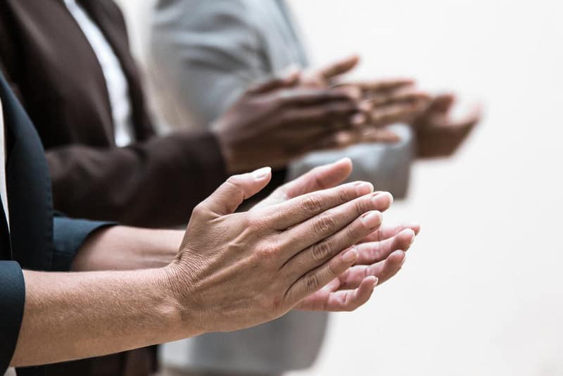 A group of business people clapping their hands at Forbes' America's Best Startup Employers.